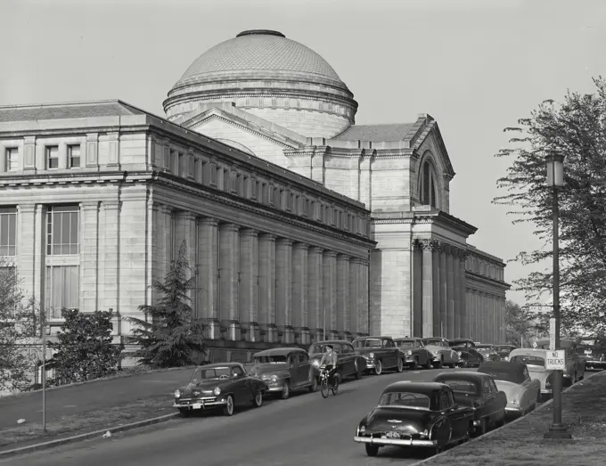 Vintage photograph. cars parked along side of street