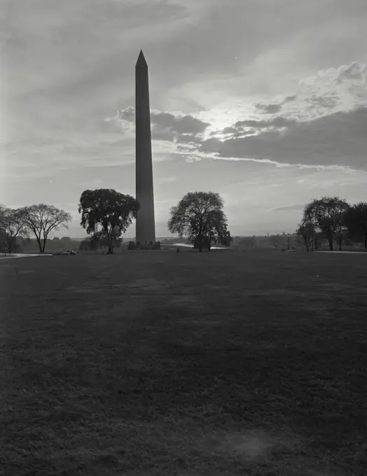 Vintage photograph. silhouette of Washington monument with sun in sky