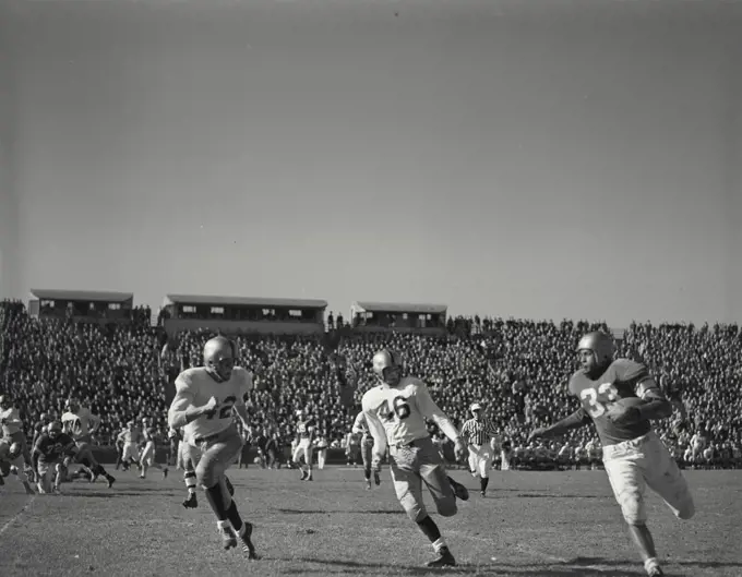 Vintage photograph. player running down sideline during Columbia vs yale at baker field in October 1951