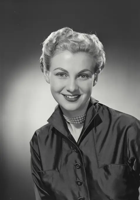 Vintage photograph. woman with short hair in button shirt smiling at camera