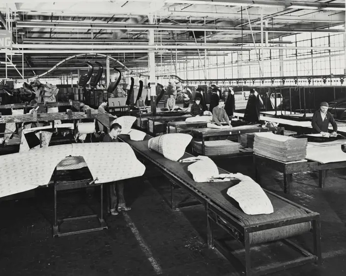 Vintage photograph. Fenders and other sheet metal parts are wrapped in protective corrugated paper for shipment by rail and motor truck to warehouses throughout the world