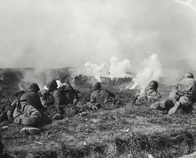 Vintage photograph. Marines of the first division fighting the Japanese held by hail in their drive for Naha, capital city of Okinawa