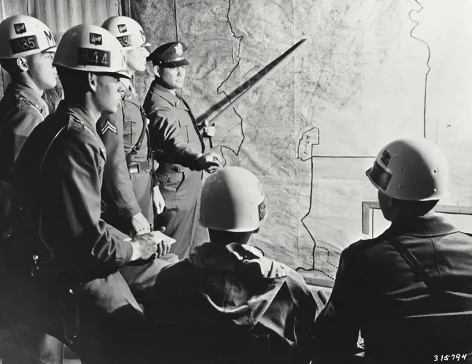 Vintage photograph. Military Police Patrols being briefed on districts they will cover during a nocturnal raid on black markets and thieves hangouts