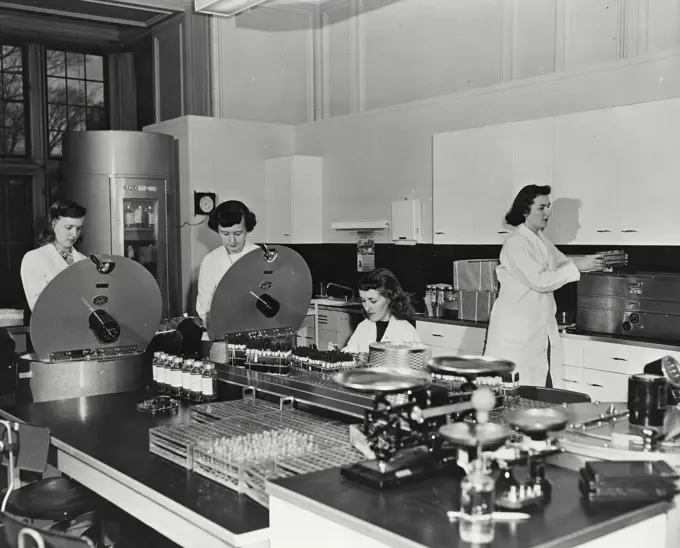 Vintage photograph. Technicians placed blood samples and centrifuge