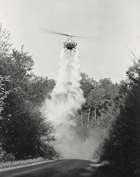 Vintage photograph. Bell helicopter performing Black fly fogging operations