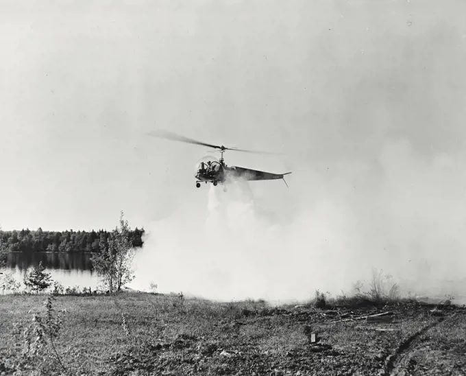 Vintage photograph. Bell helicopter performing Black fly fogging operations