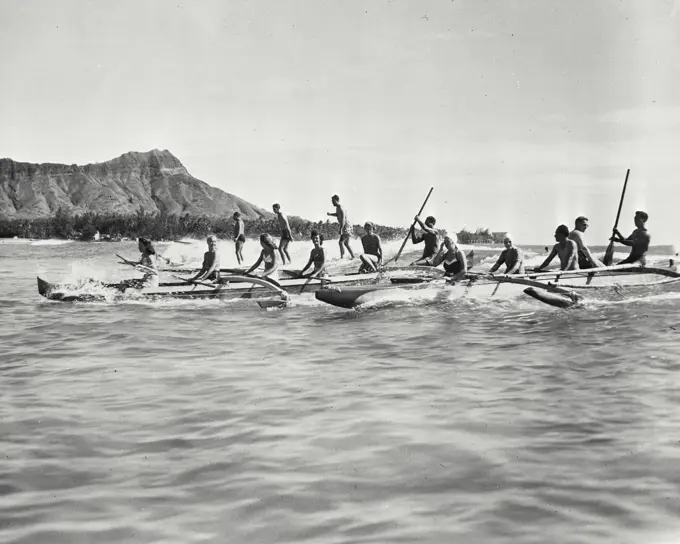 Vintage photograph. Outriggers on Waikiki Beach, Honolulu with Diamond Head in the background