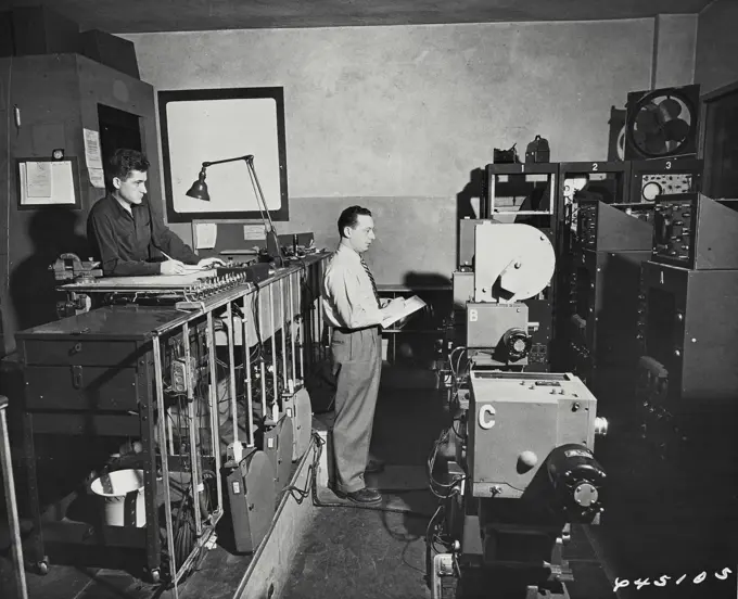 Vintage photograph. Two men in a control room while a television show being filmed