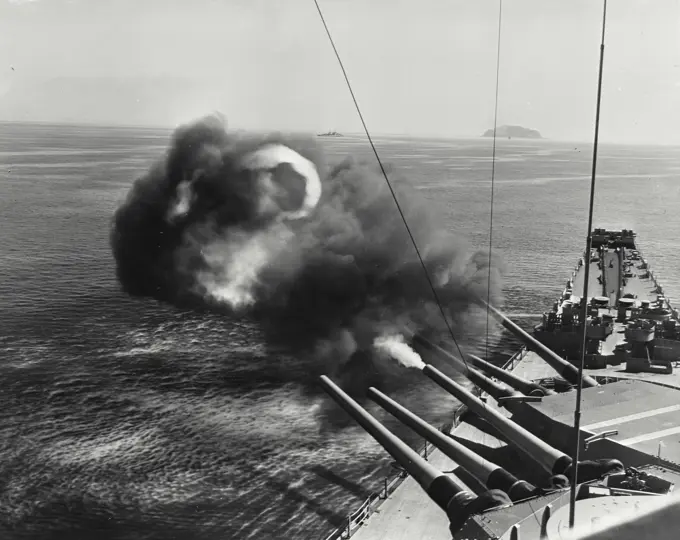 Vintage photograph. USS New Jersey main guns firing salvos in the Harbor of Wonsan, Korea