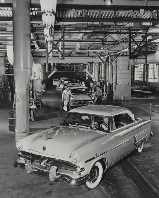 Vintage photograph. A 1953 Ford Victoria comes off the assembly line at the Ford Motor Company Rouge plant in Dearborn, Michigan