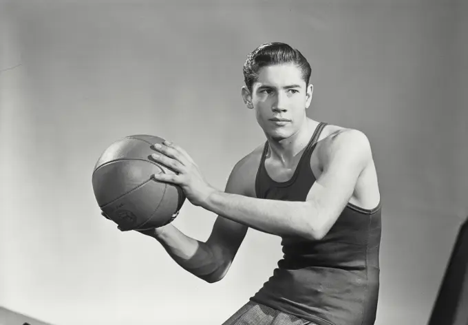 Vintage photograph. Portrait of young man with basketball