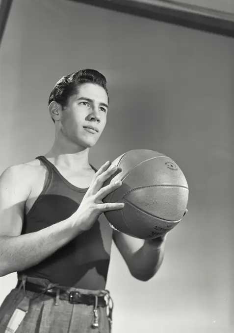 Vintage photograph. Portrait of young man with basketball