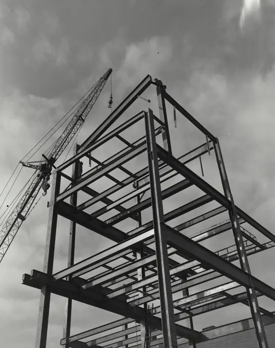 Vintage photograph. Crane carrying steel beams