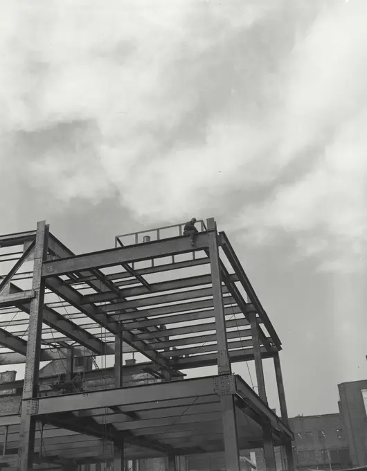 Vintage photograph. Man on steel beam structure