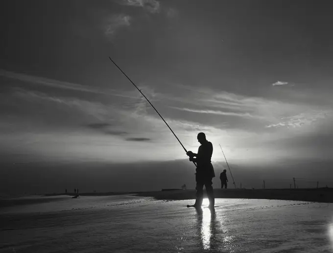 Vintage photograph. Silhouette of man fishing