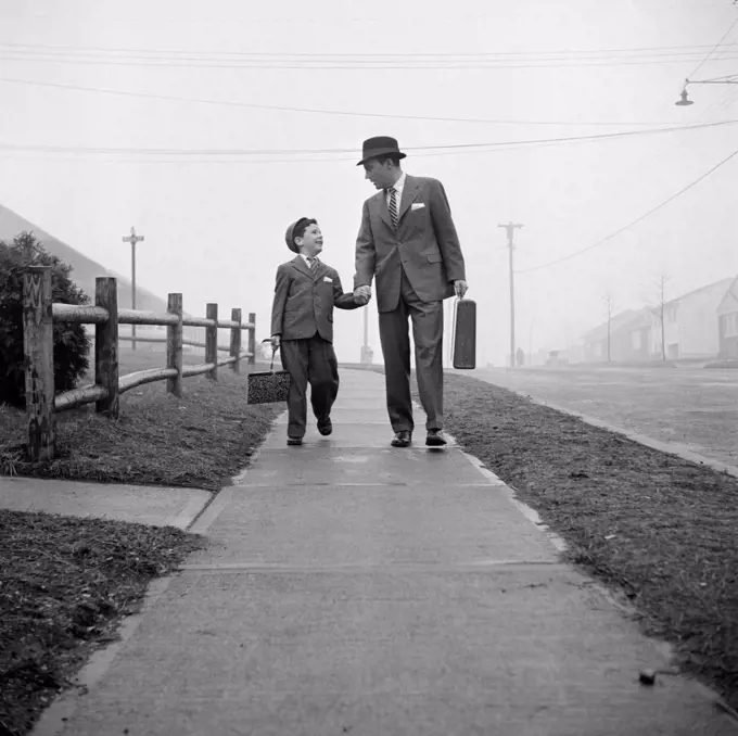 Father walking with his son on walkway