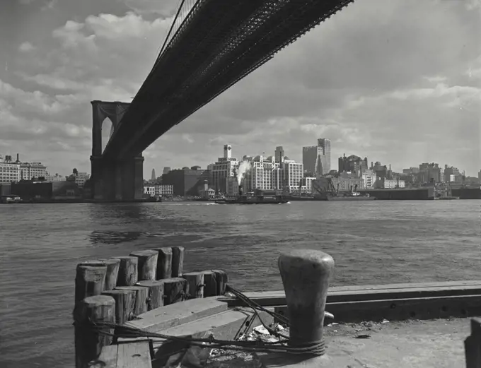 Vintage photograph. Brooklyn skyline as seen from lower Manhattan under the Brooklyn Bridge