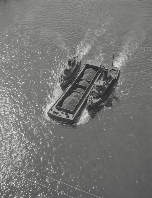 Vintage photograph. Tug boat towing barge