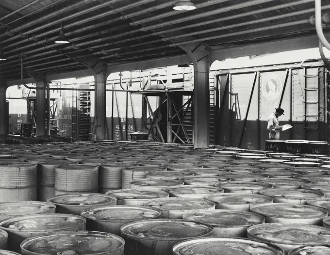 Vintage photograph. Chemicals in drums are shipped in boxcar lots from the Houston, Texas plant of Shell Chemical Corporation. The chief chemicals shipped in this manner are isopropyl alcohol, acetone, allyl alcohol, allyl chloride and D-D mixture, an agricultural chemical for killing insects destructive to root crops