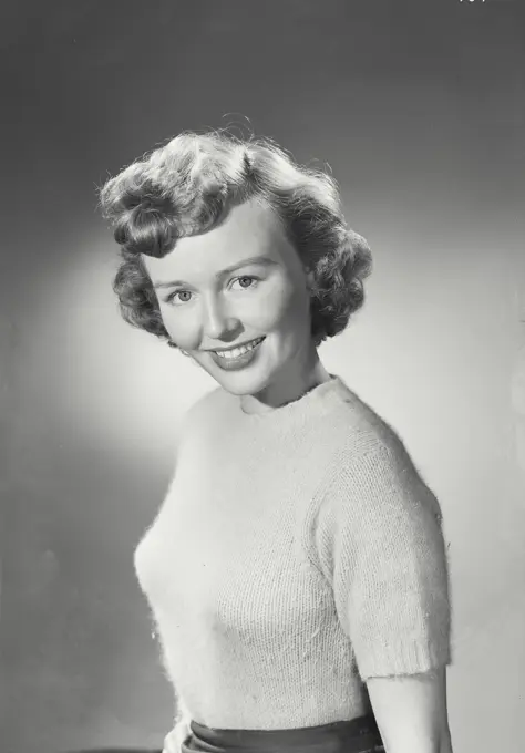 Vintage photograph. Portrait of woman in sweater smiling.