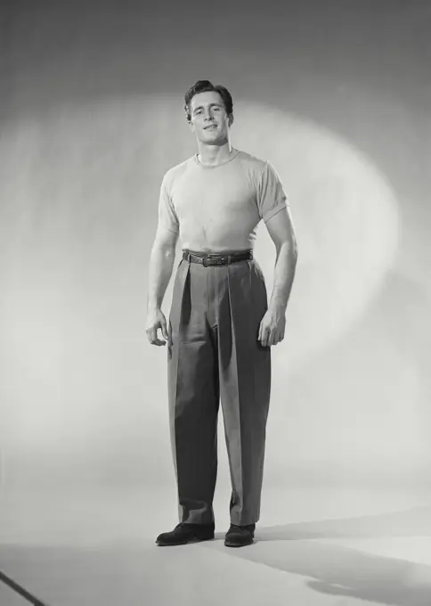 Vintage photograph. Man with shirt tucked in smirking