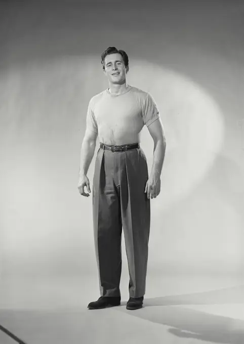 Vintage photograph. Man with shirt tucked in smirking