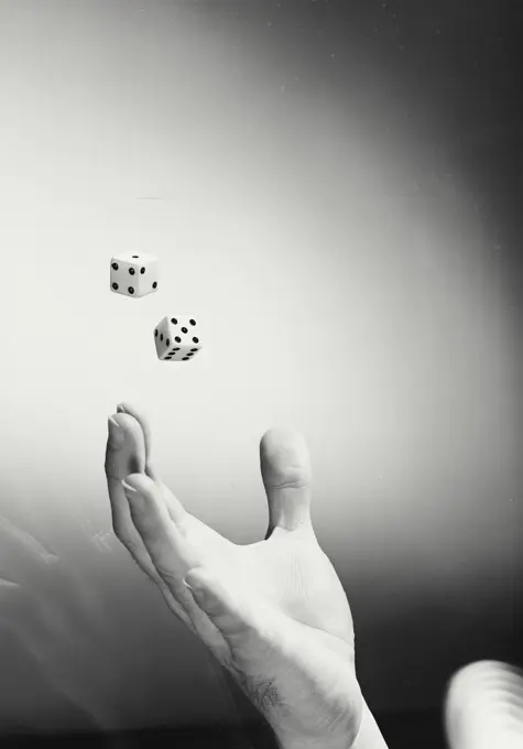 Vintage photograph. Hand rolling dice