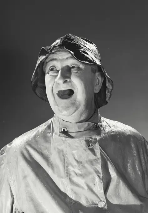 Vintage photograph. Man in rain hat and rain coat