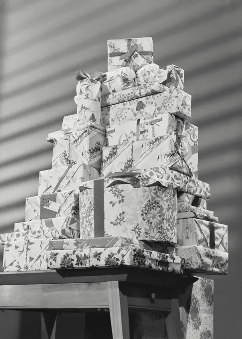 Vintage photograph. Stack of wrapped Christmas Gifts