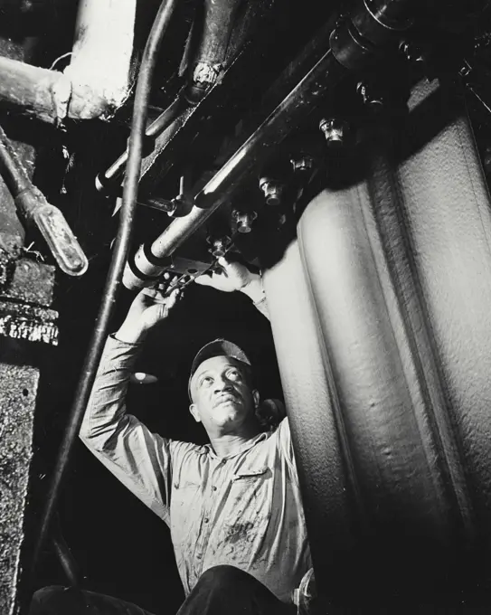 Vintage photograph. Man adjust the trimming knives of a tread tuber