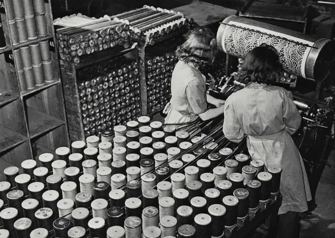 Vintage photograph. Weaving a plain Wilton carpet on a broad loom in a British cotton factory