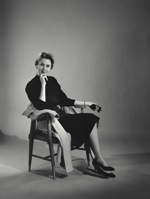 Vintage Photograph. Woman in black dress sitting in wooden chair. Frame 4