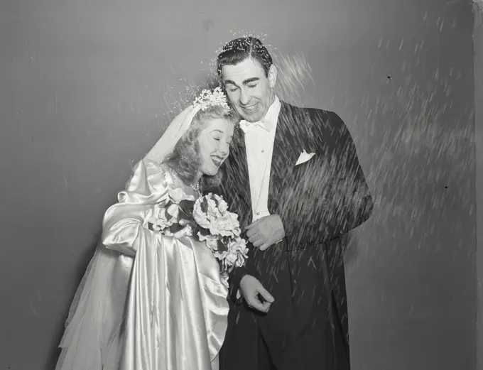 Vintage photograph. Man and Wife being showered with rice at wedding 