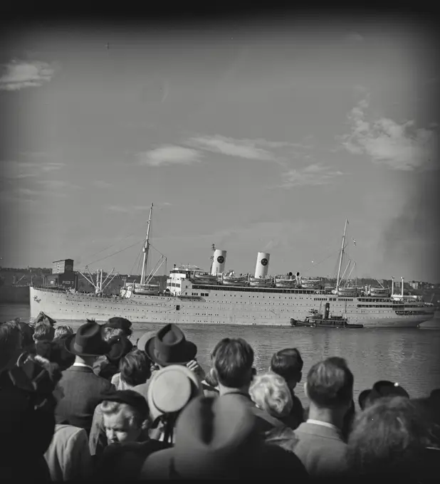 Vintage photograph. Crowd watching SS Gripsholm leave pier