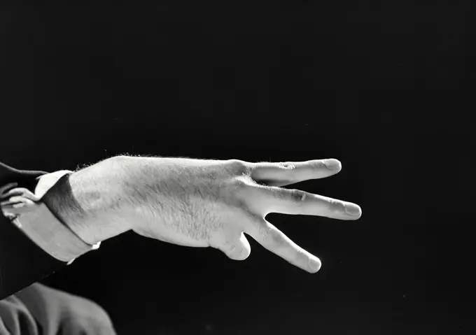 Vintage photograph. Man's hand with three fingers held up