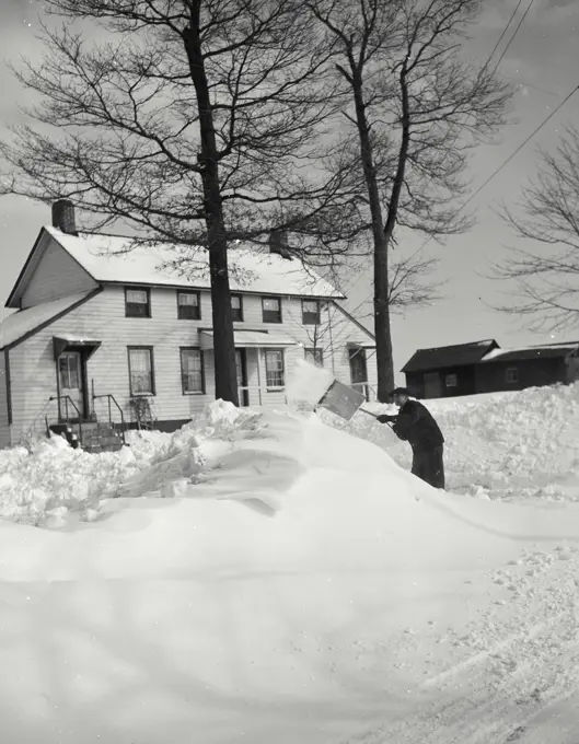 Vintage photograph. Farmer shoveling snow at North Wantagh, Long Island