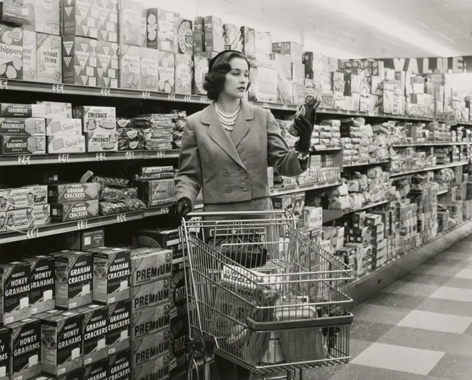 Young woman with a shopping cart in a grocery store