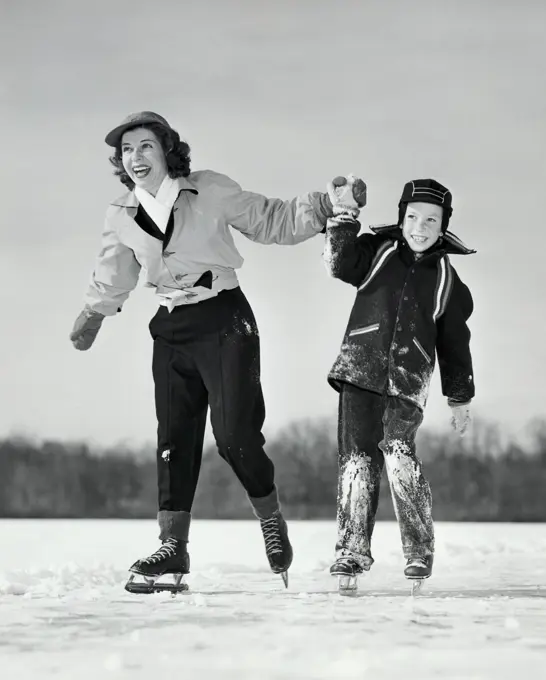 Close-up of a mother ice skating with her son