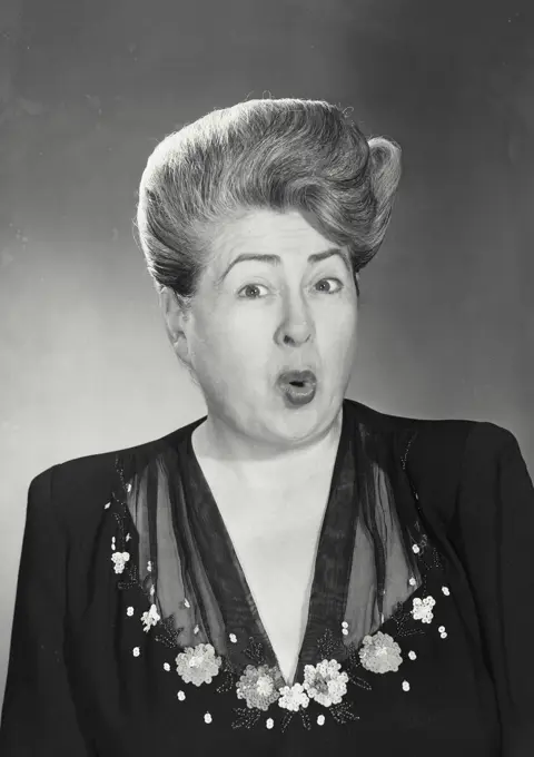 Vintage photograph. Woman with shocked look on face and eyebrows raised