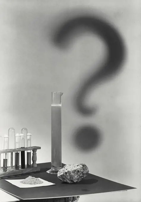 Test tube casting a shadow of question mark
