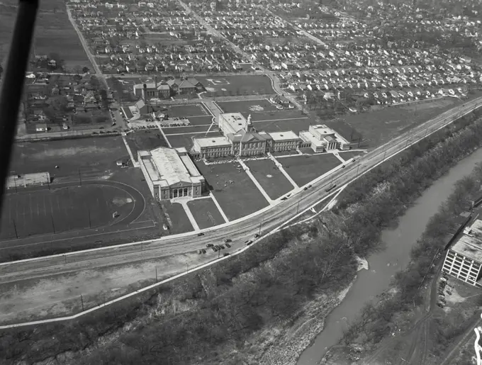 Aerial view of Richmond, Indiana showing Civic Hall on left, Richmond High School with children on front yard in the middle, and McGuire Memorial Hall with Art gallery and Auditorium on Right