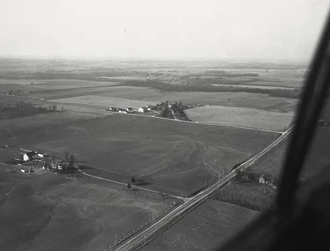Aerial View of Richmond, Indiana with erosion in field and US 27 in foreground and the residence of FH Coble M.D. in the distance