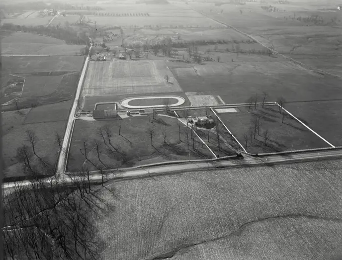 Aerial view of Richmond, Indiana showing country home of horse fancier Roy Campbell with jogging track behind house near stables, off US Route 27