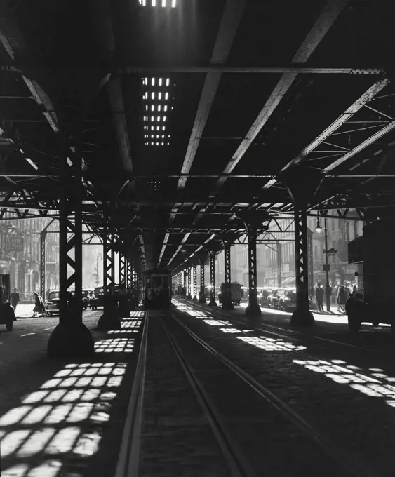View under 3rd Avenue elevated at 47th St showing railway and train