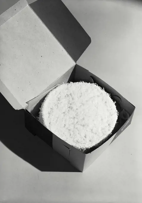 Vintage photograph. Coconut cake placed in box for delivery