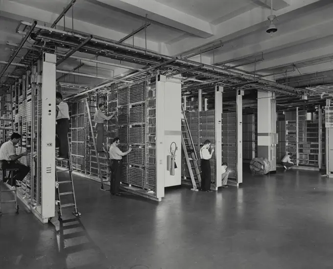 Vintage photograph. Men installing "crossbar" dial central office