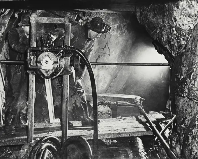 Vintage photograph. Man on machine in cobalt mine in Canada