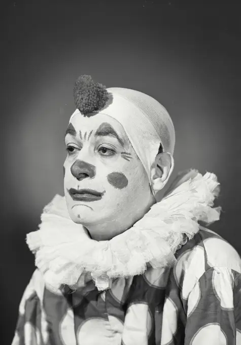 Vintage Photograph. Man in clown costume and makeup turned to side looking off camera