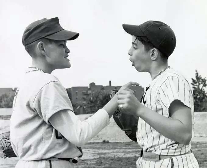 Side profile of two teenage boys arguing with each other