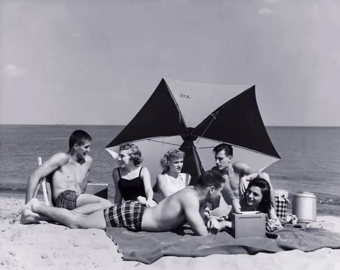 Three young couples on beach